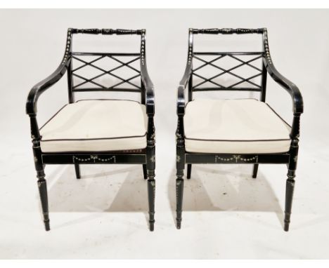 Pair of Regency-style black painted elbow chairs, the frames with cream painted decoration, pierced crossed splat and cane se