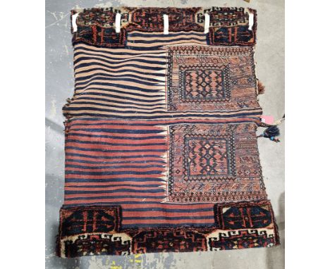 Eastern red ground saddle bag, each half with six hooked lozenges, geometric and stylised animal borders flanked by half styl