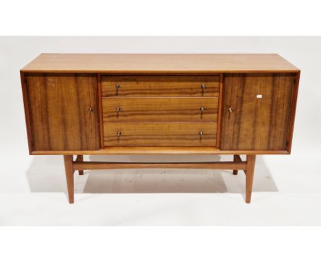 Mid-century Gordon Russell teak sideboard comprising a central bank of three drawers flanked either side by a cupboard door, 