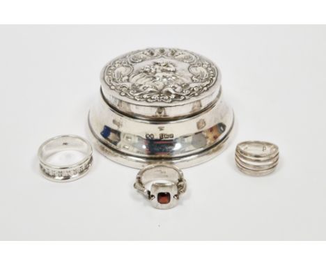 Silver trinket box, Birmingham 1982, Hampton Utilities, of circular form, the hinged lid with embossed decoration of a cherub