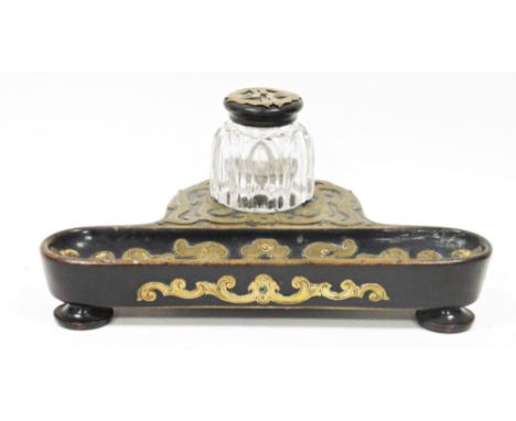 19th century ebonised inkstand with gilt brass strapwork mounts, the cut-glass inkwell fitted on a shaped stand with pen tray