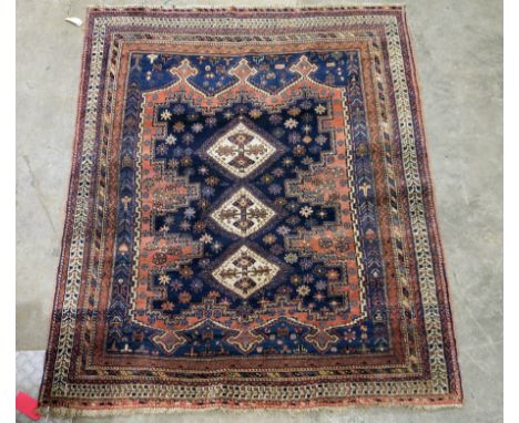 Large Eastern midnight blue ground rug&nbsp;with three central hooked lozenges on floral and geometric shape pattern field, m