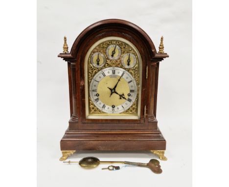 Early 20th century mahogany bracket clock, the arched case with gilt metal finials, quarter corinthian columns flanking the d