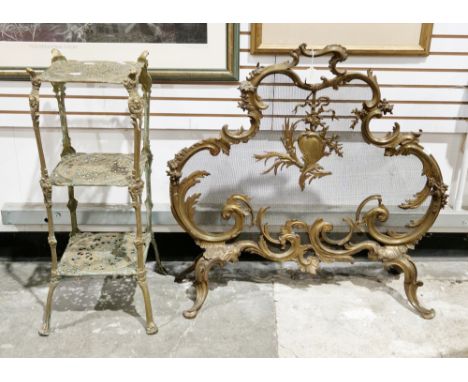 Brass firescreen&nbsp;in the rococo manner, of shaped foliate scrolling outline with a mesh interior, on four foliate scrolli