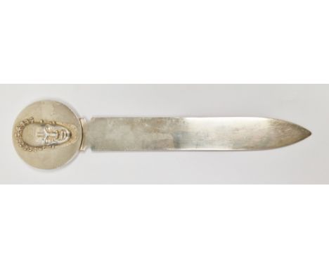 French Christofle silver plated paper knife, the terminal with raised decoration of an African face mask to one side and a ri