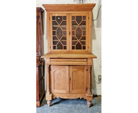 19th century continental pine glazed dresser/bookcase, the upper section with astragal glazed doors opening to two fitted she