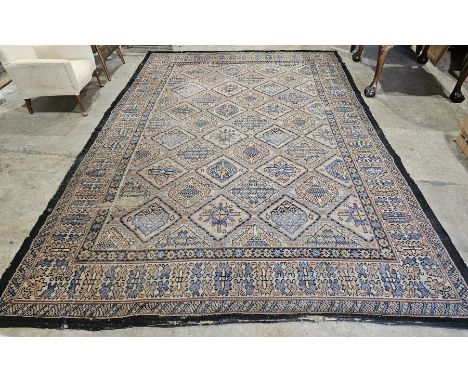 Rust-orange ground carpet&nbsp;with geometric pattern hooked lozenge trelliswork, multipole floral borders (some wear), 360cm