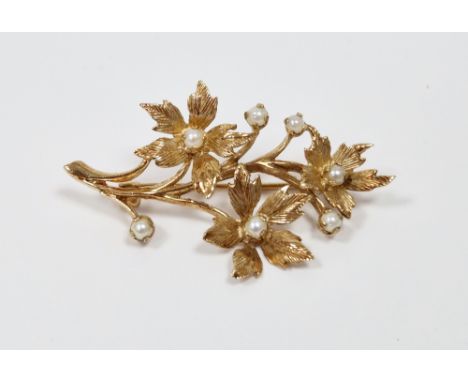 9ct yellow gold brooch in the Victorian style, in the form of a floral spray set with seed pearls, maker's mark HBJ, 4.2cm lo