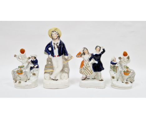 Pair of Victorian pottery zebra spill vases, late 19th century, modelled with a highlander girl and companion feeding a zebra