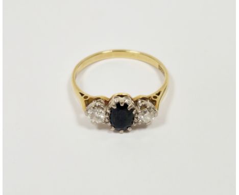 18ct yellow gold sapphire and diamond ring, comprising a central claw-set oval mixed cut sapphire flanked by two round diamon