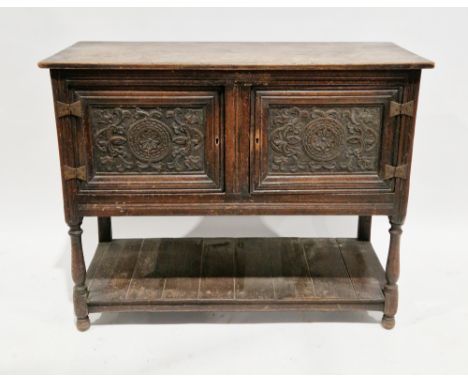 Oak dresser base&nbsp;in the 17th century manner, comprising two carved panel cupboard doors, on turned baluster and block su