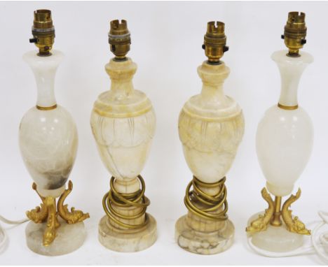 Pair of white onyx table lamps, having gilt metal supports in the form of dolphins, 38cm high and a pair of marble-effect ala