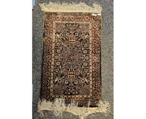 Persian style silk green ground rug with central floral motif on floral and stylised bird pattern field, multiple floral bord