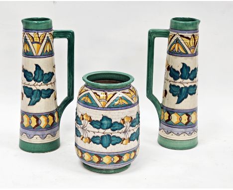Pair of Wood's pottery Arabesque pattern jugs&nbsp;by Charlotte Rhead, of tall tapering conical form with readed green ground