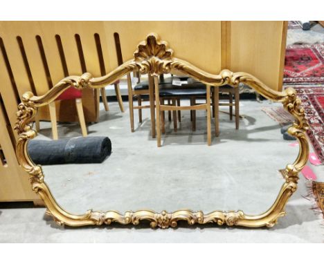 Modern gilt-framed overmantel mirror in the rococo-style, the frame moulded with shells and foliate scrolls, 86cm high x 121c