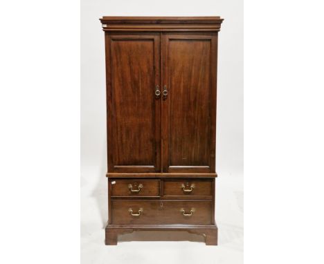 Early 20th century mahogany linenpress of small proportions in the George III manner, the two panel cupboard doors opening to