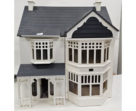 Mid 20th century white painted two storey dolls house with lift-up roof featuring attic, together with a quantity of doll's h