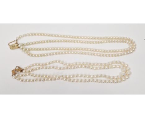 Two double-strand cultured pearl choker necklaces, one of 9ct yellow gold clasp with similar sized round pearls of approximat