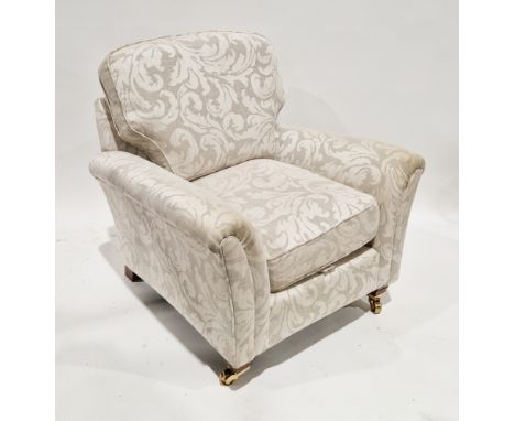 Parker Knoll armchair upholstered in a cream foliate scrolling fabric, on front mahogany-effect square tapering front legs wi