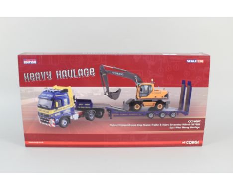 A boxed Corgi heavy haulage Volvo F H Nooteboom step frame trailer and Volvo excavator wheel EW180B
