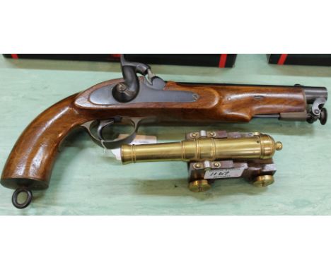 An inert percussion pistol with a model cannon