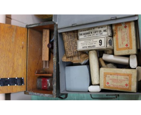A U.S.A. first aid tin with contents with a British water testing kit in wooden box