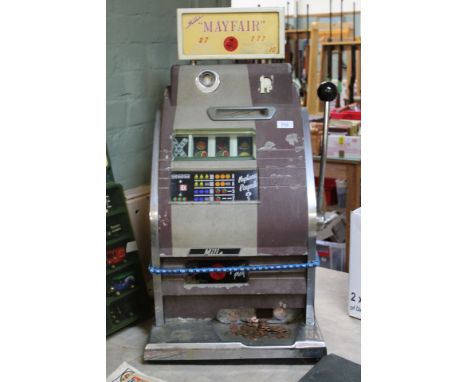 A Mills Mayfair one armed bandit, this items is sold as a collectors item only and has not been subject to an electrical safe