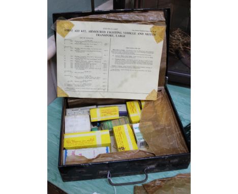 A military first aid tin marked for A.F.V. with some contents
