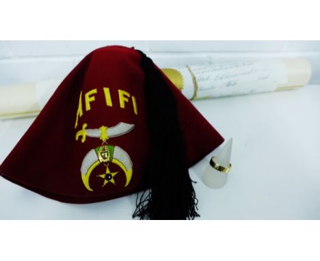 Masonic collection to include an unmarked gold ring with black enamel insignia together with a red felt Afifi cap and certifi