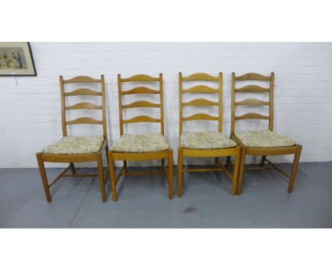 A set of four Ercol ladder back dining chairs with upholstered seat pads (4) 