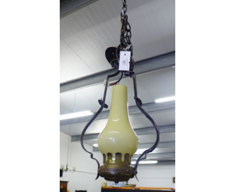 A wrought iron hanging lantern with opaque glass shade, approx 50cm long