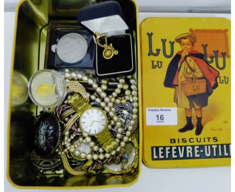 An enamel tin containing a Gent's gold plated Rotary wristwatch, a selection of costume jewellery to include earrings, faux p