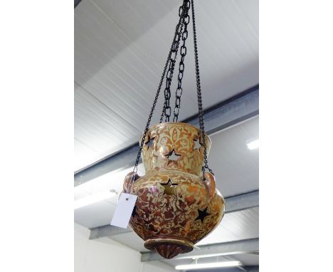 An Hispano Moresque style copper lustre hanging lantern with star apertures, complete with hanging chains, 30cm