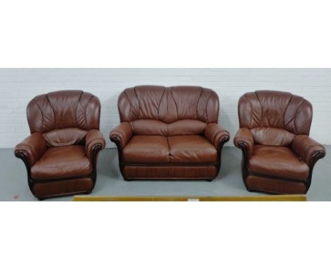 A leather three piece lounge suite comprising two-seater sofa and two easy chairs