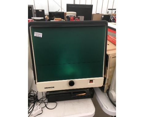 A MINOX ILLUMINATED ENLARGER 