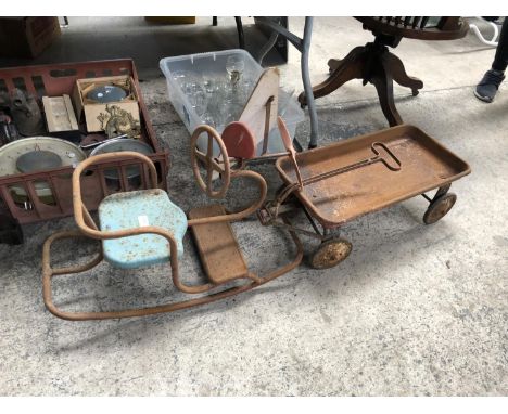 A VINTAGE METAL CHILDREN'S SEAT AND TROLLEY 