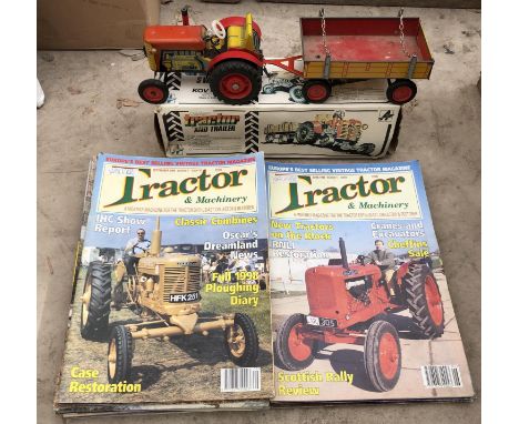 A BOXED CLOCKWORK TINPLATE TRACTOR AND TRAILER MODEL TOGETHER WITH A GROUP OF CLASSIC TRACTOR MAGAZINES 