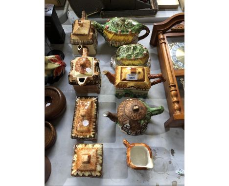 A GROUP OF CERAMIC COTTAGE TEA WARES TO INCLUDE TEAPOTS ETC 
