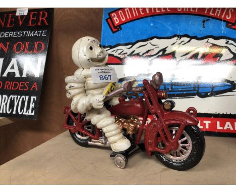 A CAST METAL MICHELIN MAN ON RED MOTOR BIKE MODEL 