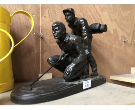 A BRONZE FIGURE OF A GOLFER AND HIS CADDY (CADDY A/F ON BACK OF LEG) 