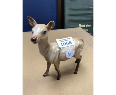 A BESWICK CERAMIC MODEL OF A DOE, EAR RESTORED. 