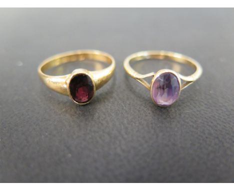 An 18 ct gold ring set with an oval amethyst in a collet setting - Ring size N - Weight approx. 2.1 grms and a 22 ct dress ri