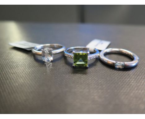 Three gem-set rings - To include topaz, cubic zirconia and peridot - Stamped 925 - Ring sizes L and N 1/2 - Weight approx 10.
