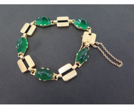 An 18ct gold green-gem panel bracelet - With French marks - Length approx 20cms - Weight approx 27.1gms
Condition Report: Goo