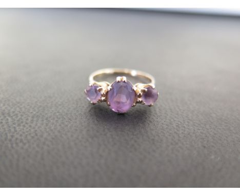 A 9ct gold amethyst three-stone ring - Partial hallmark - Ring size L 1/2 - Weight approx 2.2gms
Condition Report: Good - Wit