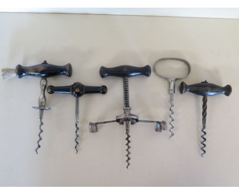 Five vintage corkscrews - including four wooden handled, one with brush and one metal corkscrew