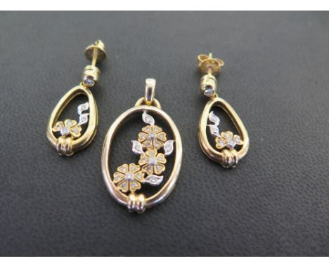 An openwork floral pendant set with brilliant-cut diamonds - Length 3.5cms - Together with a pair of matching ear pendants - 