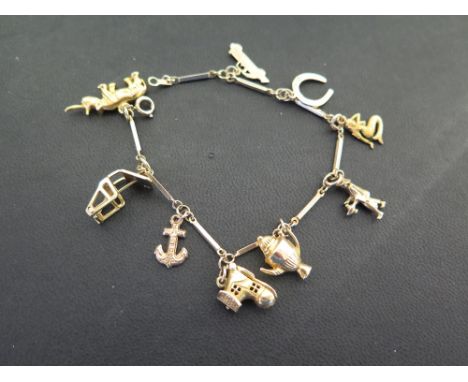 A charm bracelet - The bar-link bracelet suspending nine charms - Bracelet and charms with marks indicating 9ct gold - Length