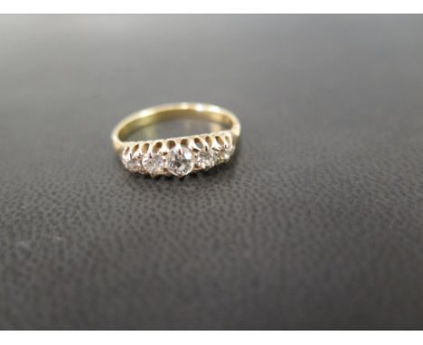 A diamond five-stone ring - The old-cut diamonds in a raised claw setting - Stamped 18ct - Ring size M - Weight approx 2.7gms