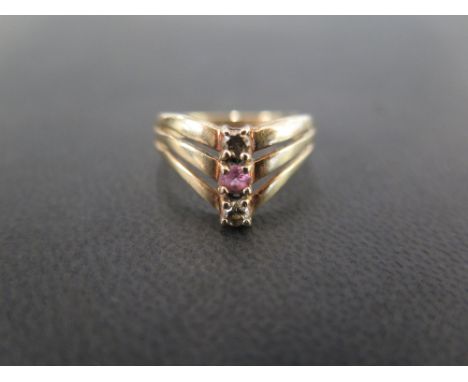 A 9 ct gold three stone ring set with two diamonds flanking possibly a pink topaz - size L 1/2 - Weight approx. 2.3 grms 
Con